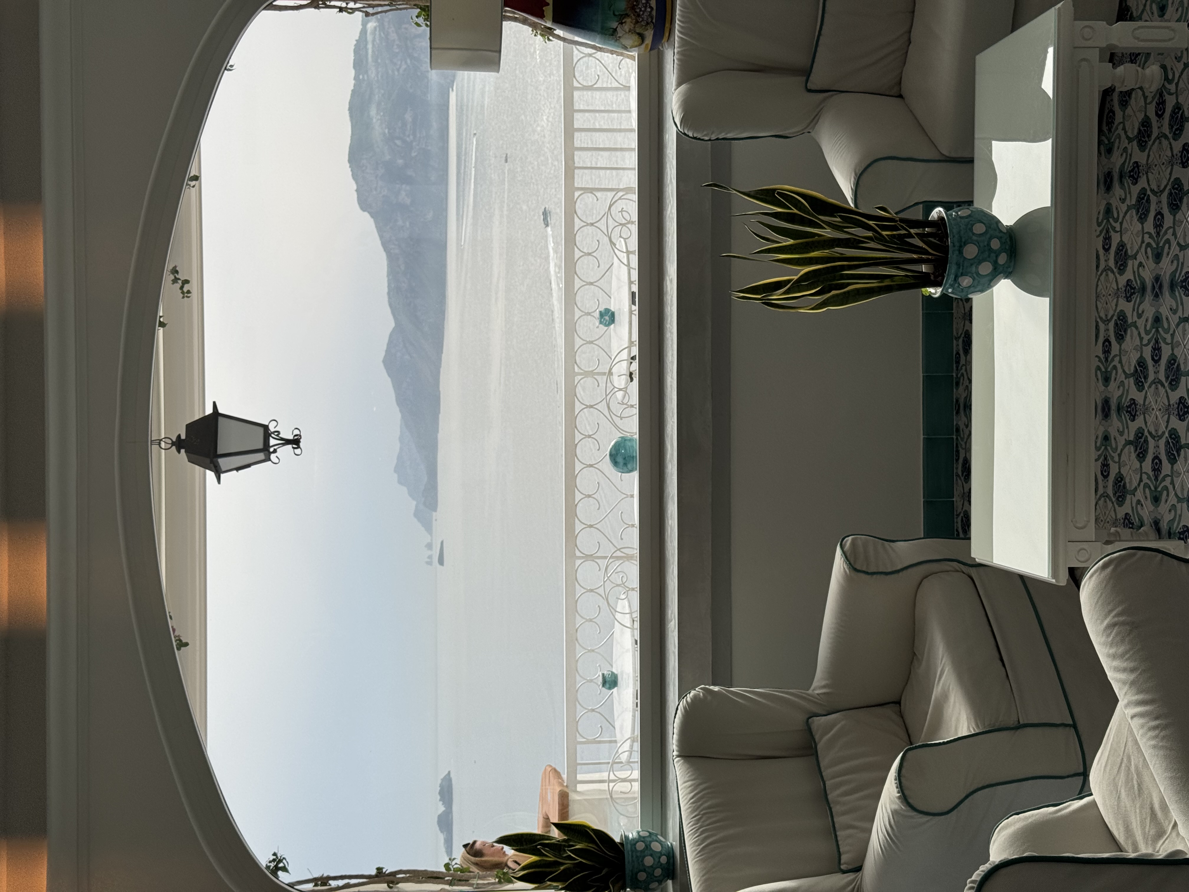 Grand Hotel Tritone lobby with round arch window framing the sea view